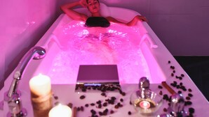 A person relaxing in a bathtub with a control panel in front of them. - Grifid Hotel Encanto Beach (Varna)