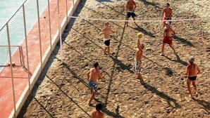 A volleyball game on a sandy court with a pool in the background. - Scaleta Beach (Rethymno)