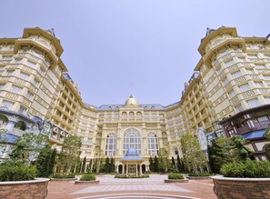 A grand, symmetrical building with a central dome and multiple balconies.