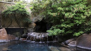 A tranquil garden with a small waterfall, a bamboo fence, and a clear pool. - Izumokamigami Enmusubi No Yado Konya (Matsue)