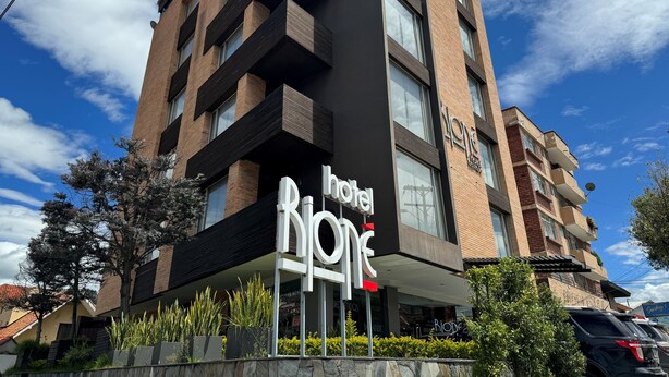 A hotel named 'hotel one' with a modern design, featuring a prominent sign, multiple balconies, and a clear view of the sky. - Rione Hotel Boutique (Cuenca)