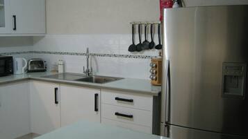 Apartment, 2 Bedrooms | Private kitchen | Fridge, microwave, stovetop, coffee/tea maker