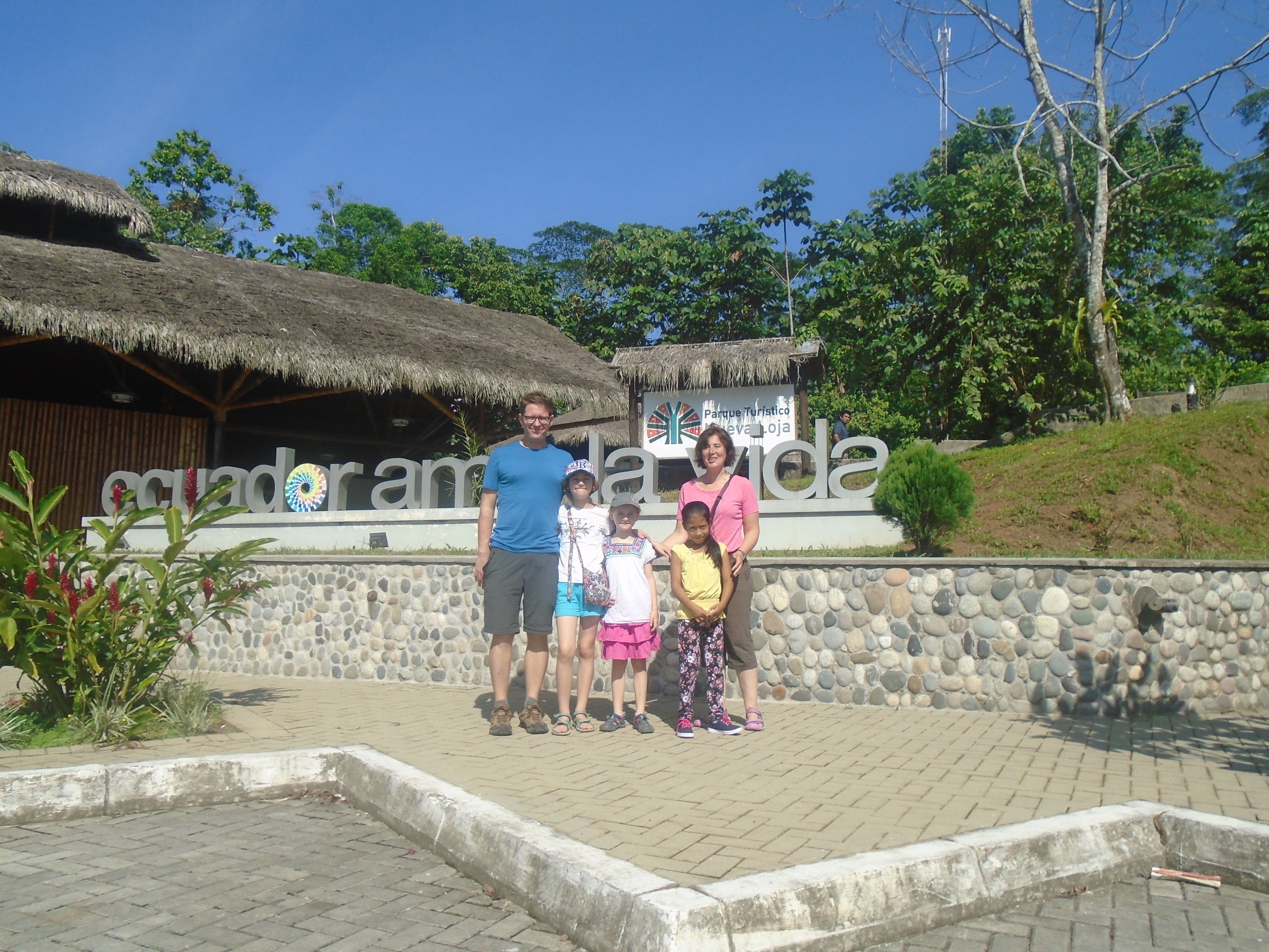 A family posing in front of a sign for Parque Turistico La Vida.