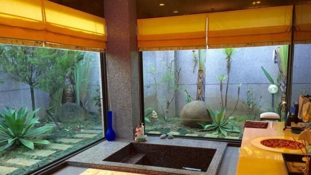 A modern bathroom with a large bathtub, a small sink, and a large window. - Tainan California Villa (Tainan)