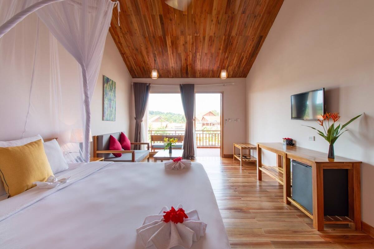 Superior Triple Room, 2 Queen Beds, Garden View | Minibar, in-room safe, desk, laptop workspace