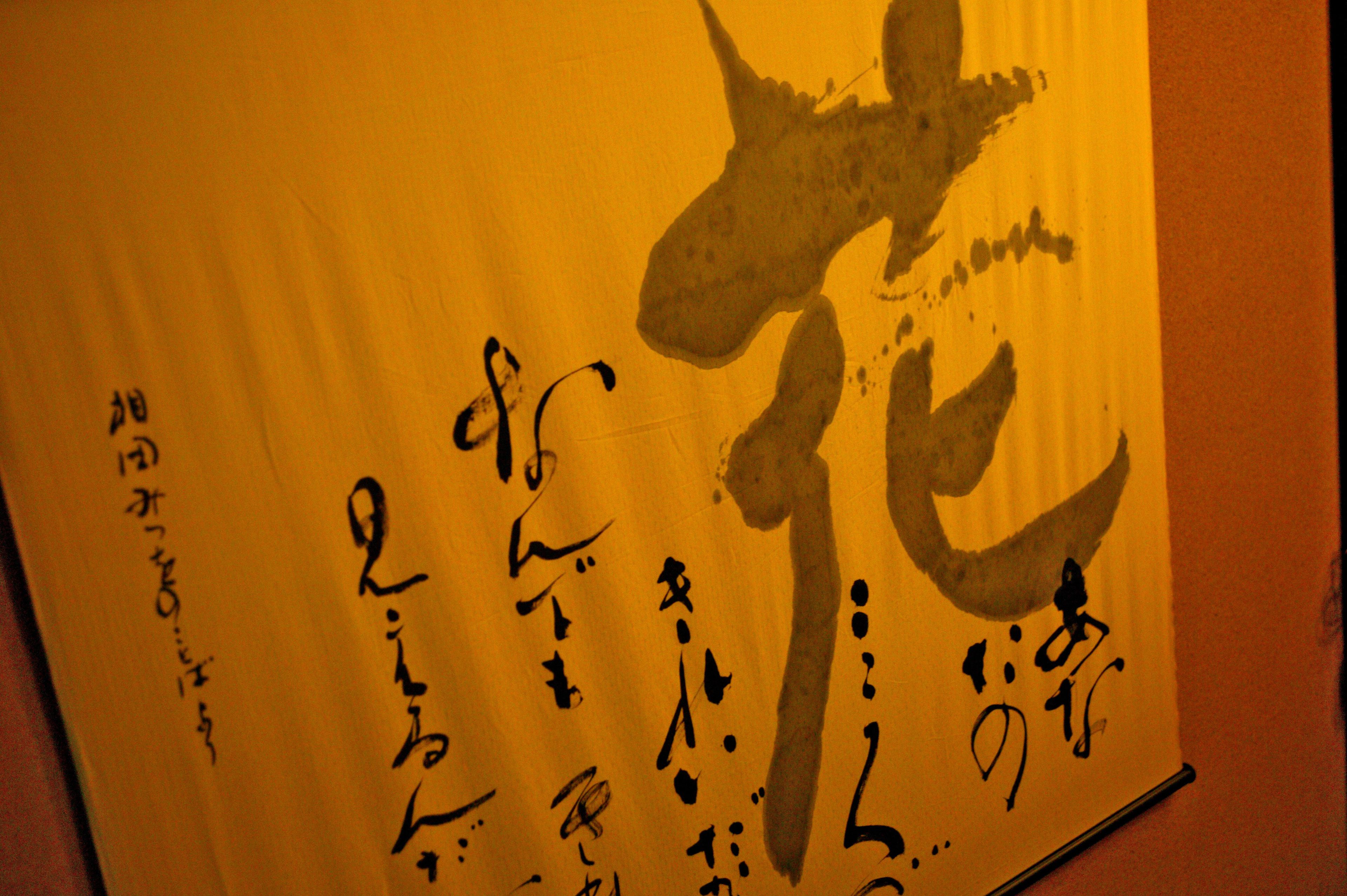 A wall with calligraphy and Japanese characters.