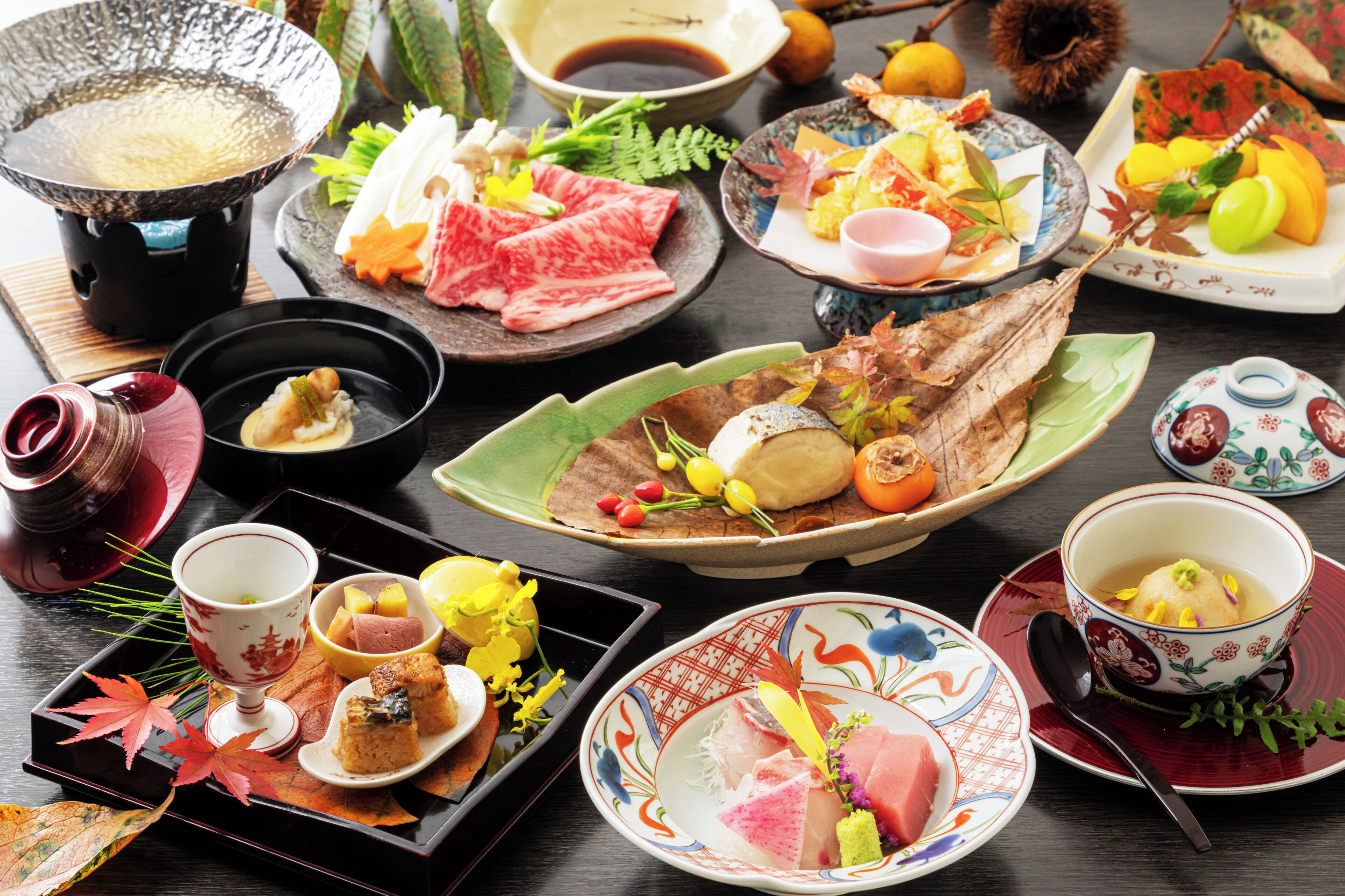 A variety of traditional Japanese dishes and beverages on a table.