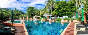 A pool area with lounge chairs, a hot tub, and a small building with a roof. - Baan Khaolak Beach Resort (Takua Pa)