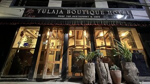 A building with a sign reading "TULAJA BOUTIQUE HOTEL" and "ROOF TOP RESTAURANT & CAFE HOTEL". - Tulaja Boutique Hotel (Bhaktapur)