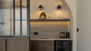 Cozinha moderna com armários de madeira, geladeira preta e forno embutido.