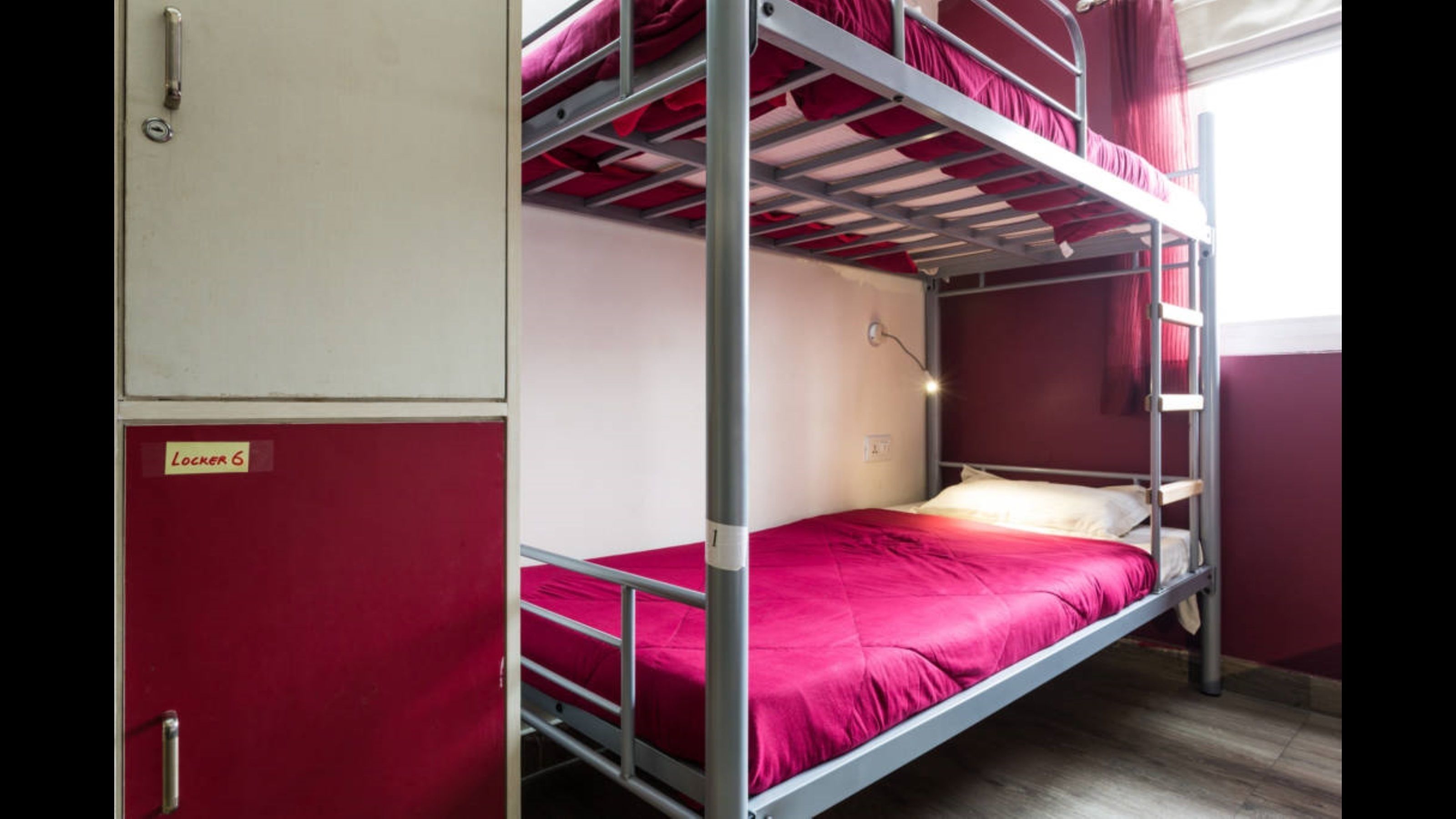 A bunk bed room with a red door labeled "Locker 6".