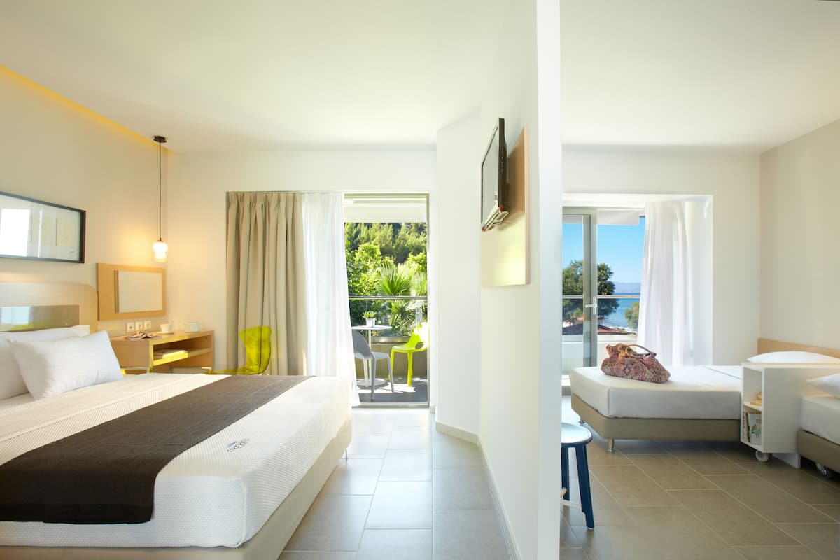 Deluxe Room, Partial Sea View | In-room safe, desk, blackout drapes, soundproofing