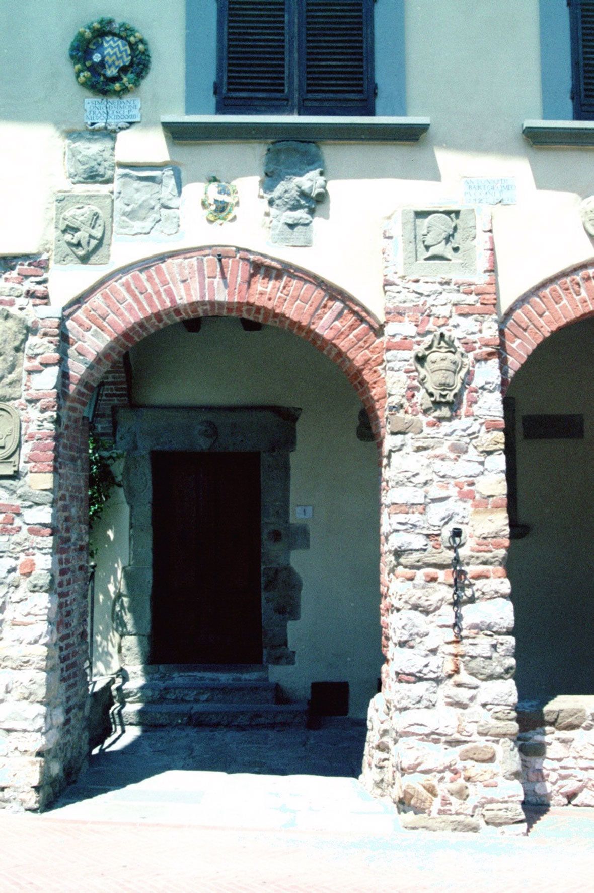A building with stone arches and a wooden door.