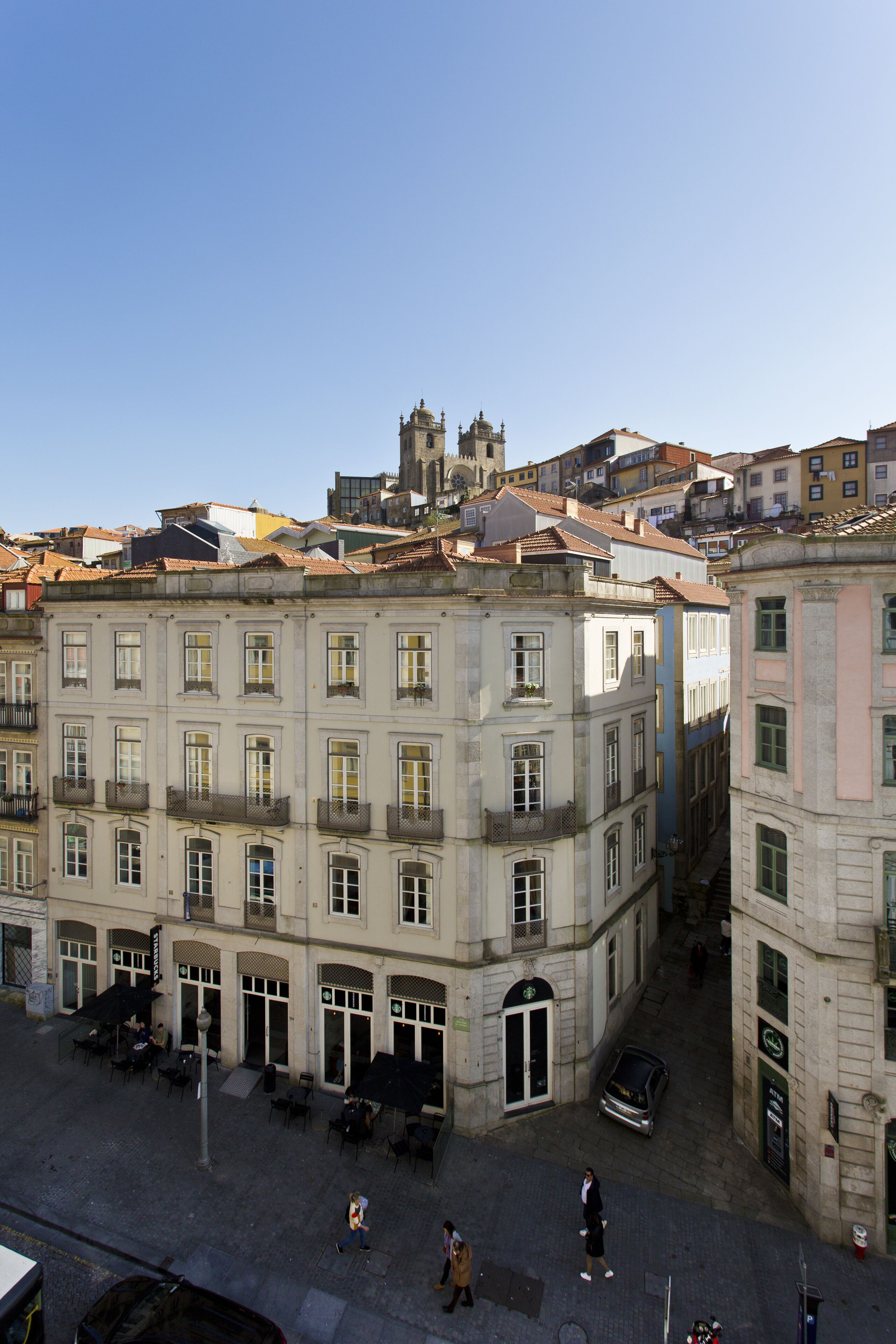 A historic building with a central courtyard, featuring a fountain and outdoor seating.