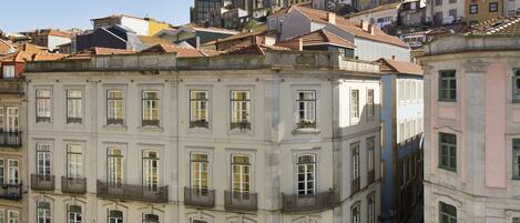 A historic building with a central courtyard, featuring a fountain and outdoor seating.