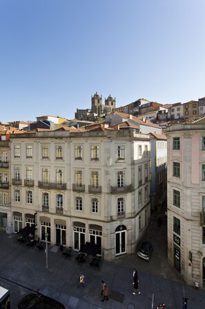 A historic building with a central courtyard, featuring a fountain and outdoor seating.