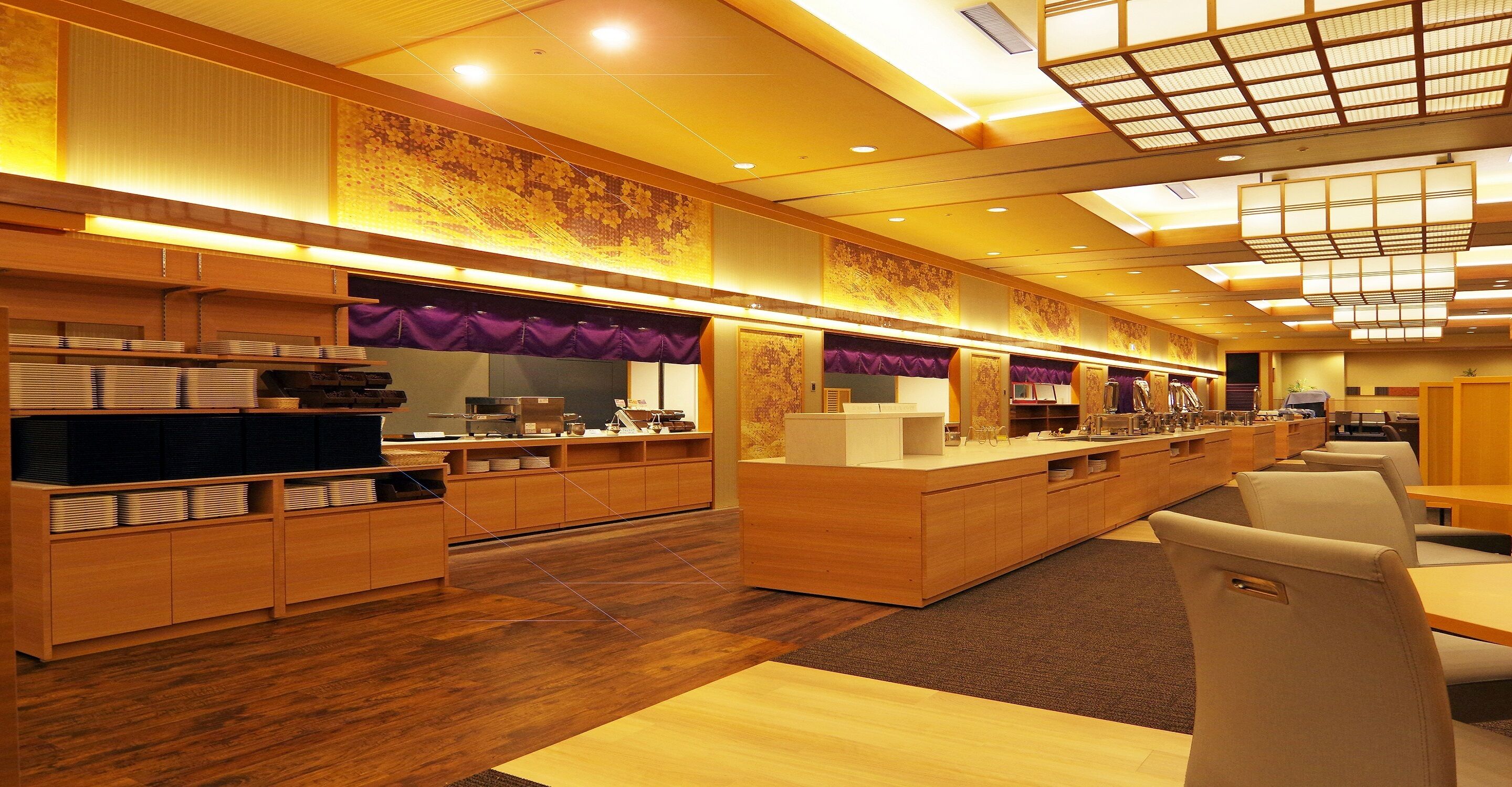 A modern hotel lobby with wooden reception desks, a central counter, and seating areas.
