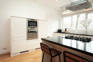 Deluxe Apartment, 3 Bedrooms | Private kitchen | Full-size fridge, microwave, stovetop, dishwasher