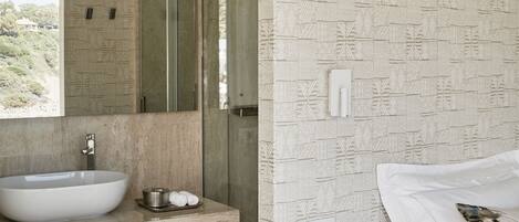 Une salle de bain moderne avec un grand lavabo, un miroir et un luminaire suspendu.