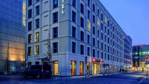 A modern hotel building with a prominent 'ibis' logo, multiple floors, and a glass facade. - ibis Leipzig City (Leipzig)