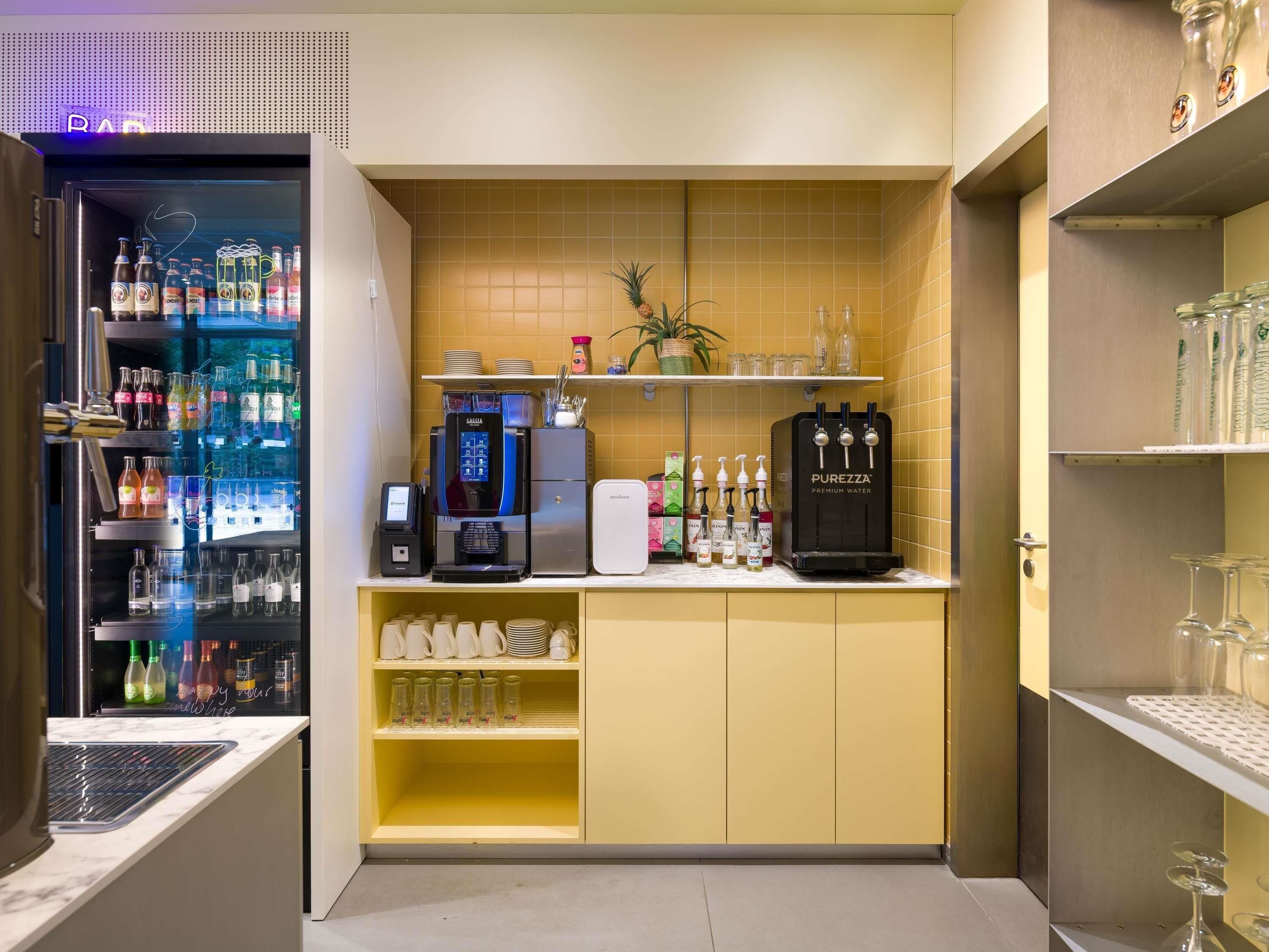 A bar area with a refrigerated drink dispenser, a coffee machine, and a water dispenser.