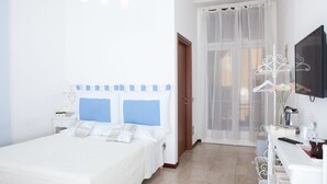 Ein Hotelzimmer mit Bett, Nachttisch und Schreibtisch mit Stuhl.