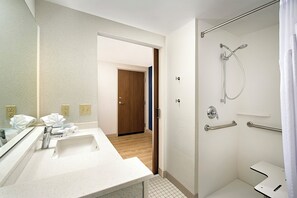 A modern bathroom with a white sink, mirror, and shower. - Holiday Inn Express & Suites Altoona by IHG (Altoona)