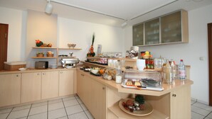 Una cocina moderna con isla integrada, equipada con distintos electrodomésticos y provista de alimentos.