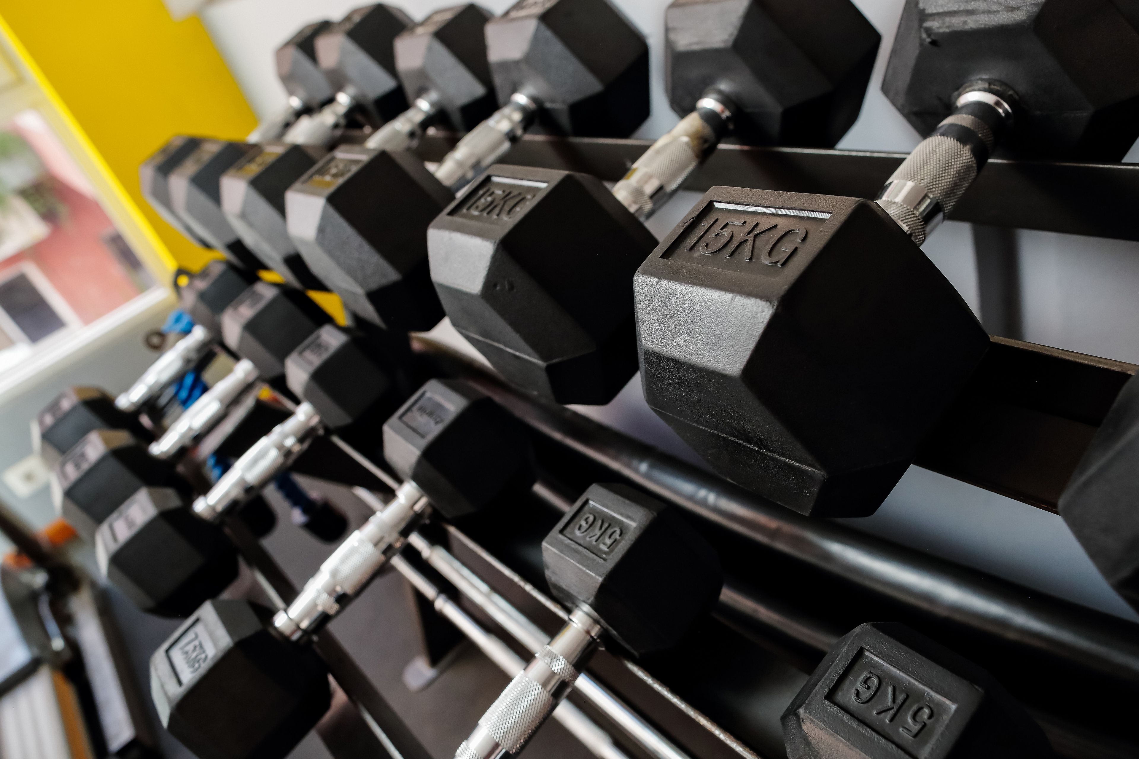 A rack of dumbbells with weight markings.