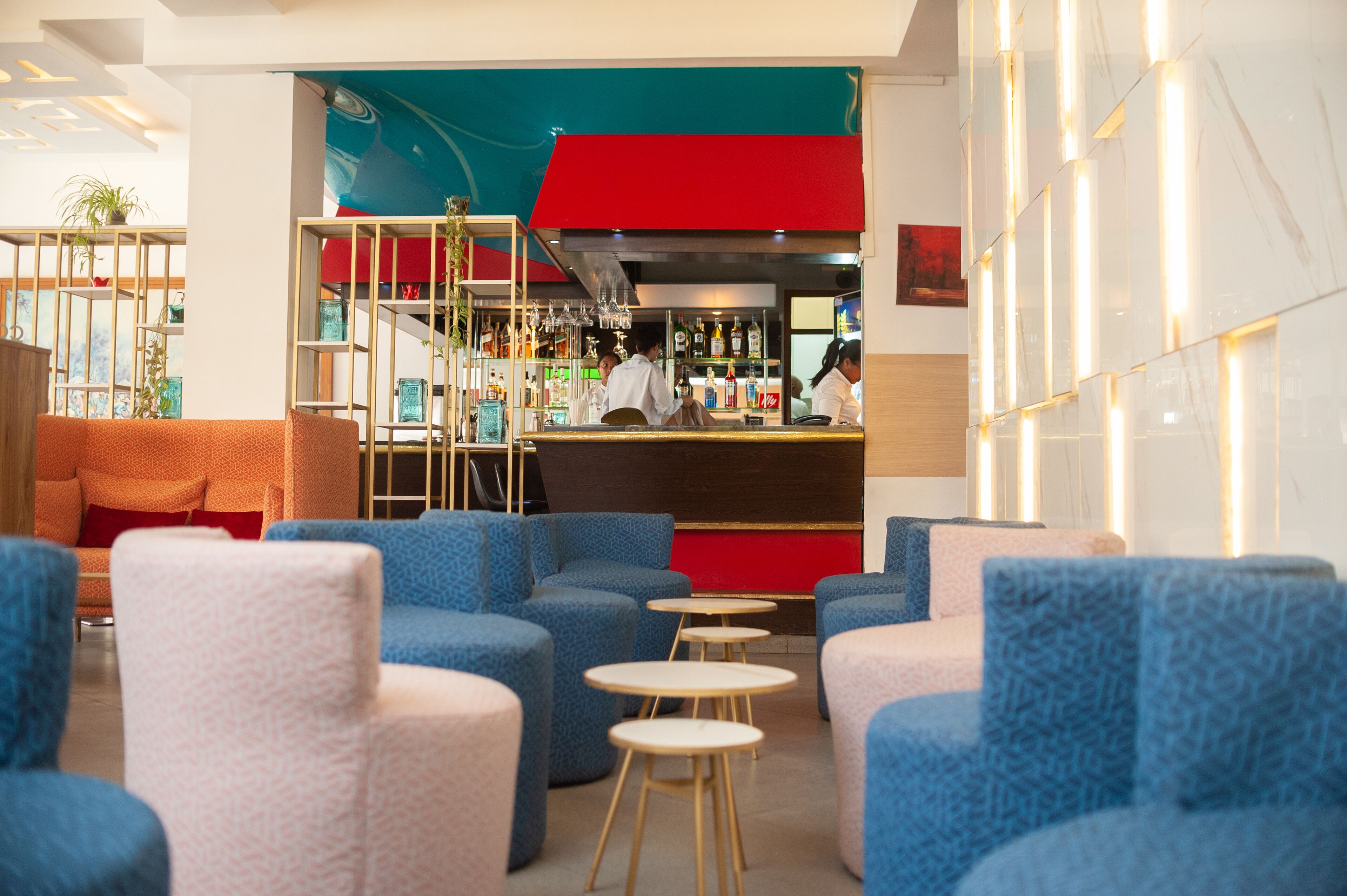 A modern bar area with seating and a bar counter.