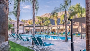 A pool area with lounge chairs, palm trees, and a mountain backdrop. - WorldMark Palm Springs (Palm Springs)