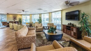 A spacious lobby with a large sofa, armchairs, a coffee table, and a TV. - WorldMark Palm Springs (Palm Springs)