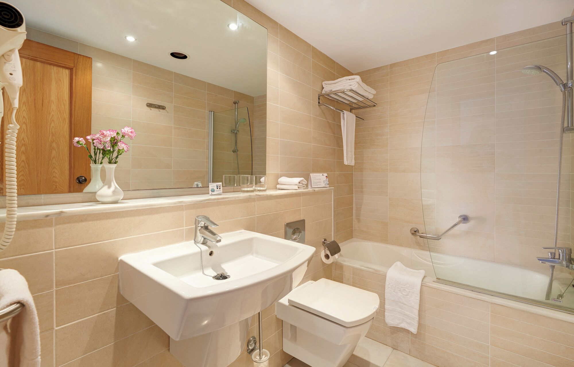 A modern bathroom with a sink, toilet, and shower.