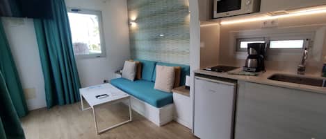 A compact kitchenette with a built-in microwave, coffee maker, and dishwasher.