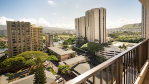 A high-rise building with multiple floors, surrounded by other buildings and greenery.