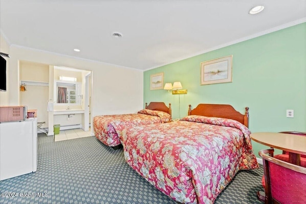 A hotel room with two beds, a desk, a chair, a lamp, and a picture on the wall. - Top Hill Motel (Saratoga Springs)
