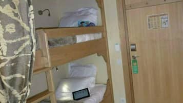 A bunk bed room with a wooden ceiling and a door with a lock.