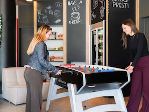 A foosball table in a room with black walls and chalkboard art. - ibis budget Bern Expo (Bern)