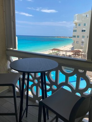 A balcony with a view of a beach and ocean. - Cancun Plaza Condo Mexico (Cancun)