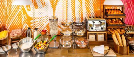 A buffet setup with various food items and a toaster.