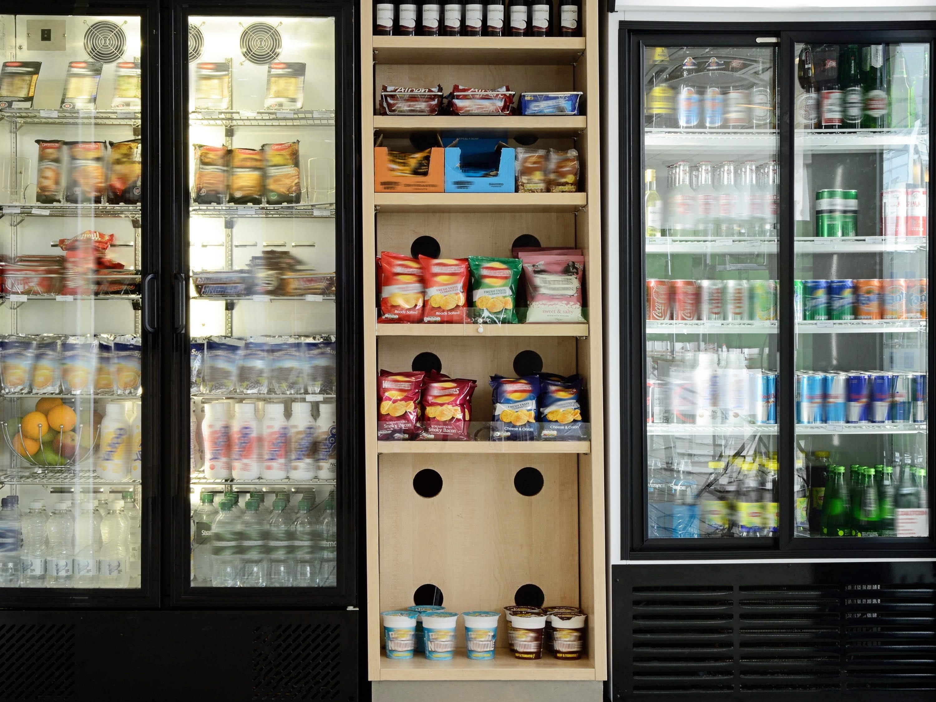 A refrigerated display case with various food items and beverages.