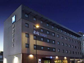 A modern hotel building with a prominent 'HOTEL' sign on the left and 'ibis budget' signage on the facade. - ibis budget London Hounslow (Hounslow)