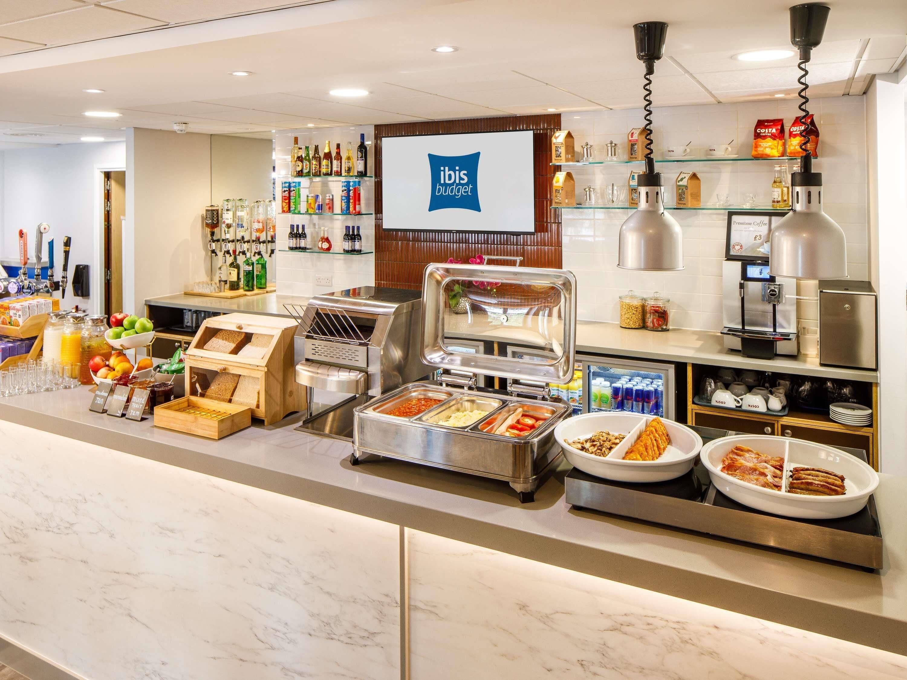 A buffet area with various food options, a coffee station, and a minibar.