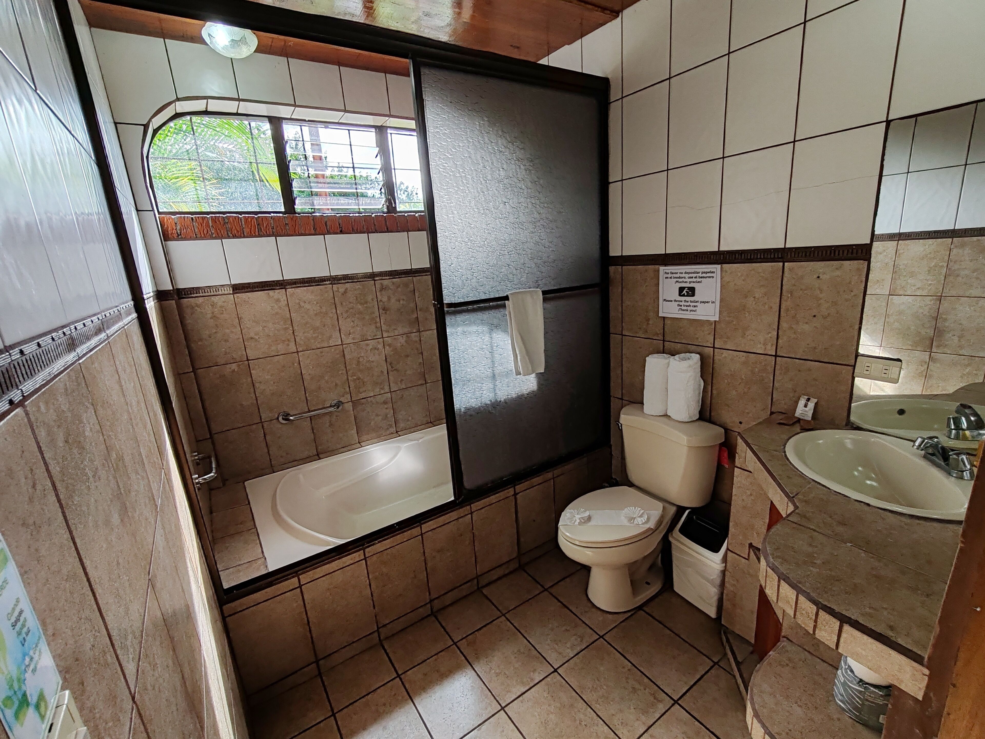 A bathroom with a bathtub, toilet, and sink.