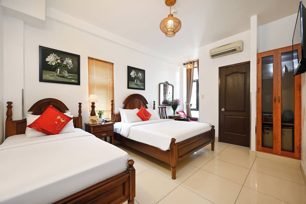 Family Triple Room, Garden View | Minibar, in-room safe, desk, laptop workspace