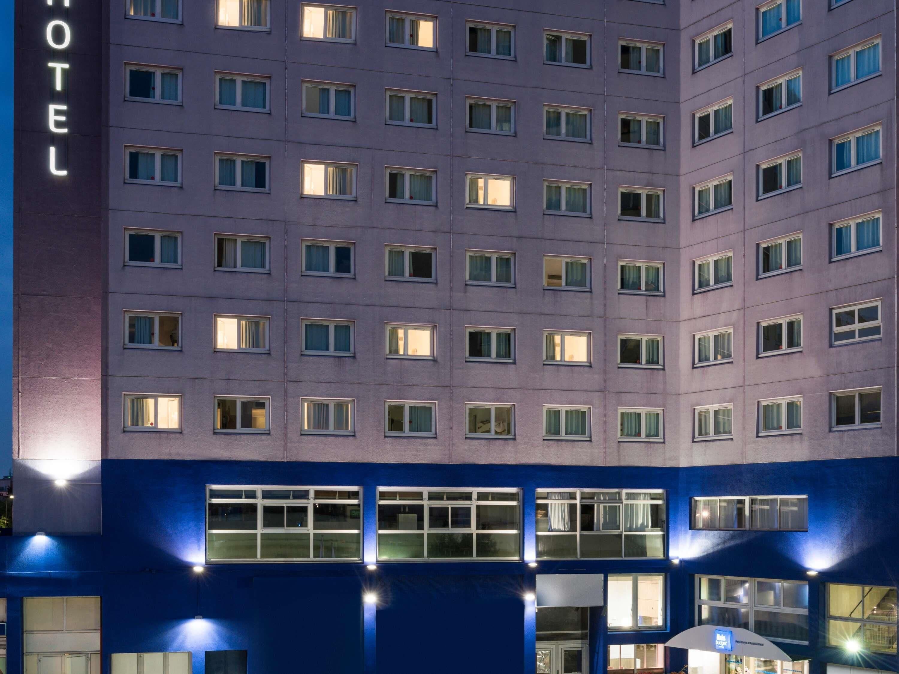 A multi-story hotel with numerous windows and a prominent 'HOTEL' sign on the facade.
