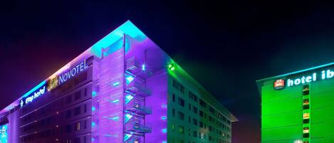 A hotel with a modern design, featuring multiple floors and balconies.
