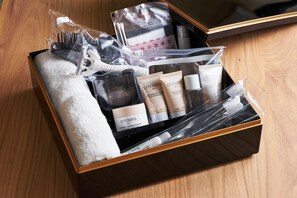 A neatly packed travel toiletry set in a black box with a wooden interior. - Gajoen Tokyo (Tokyo)