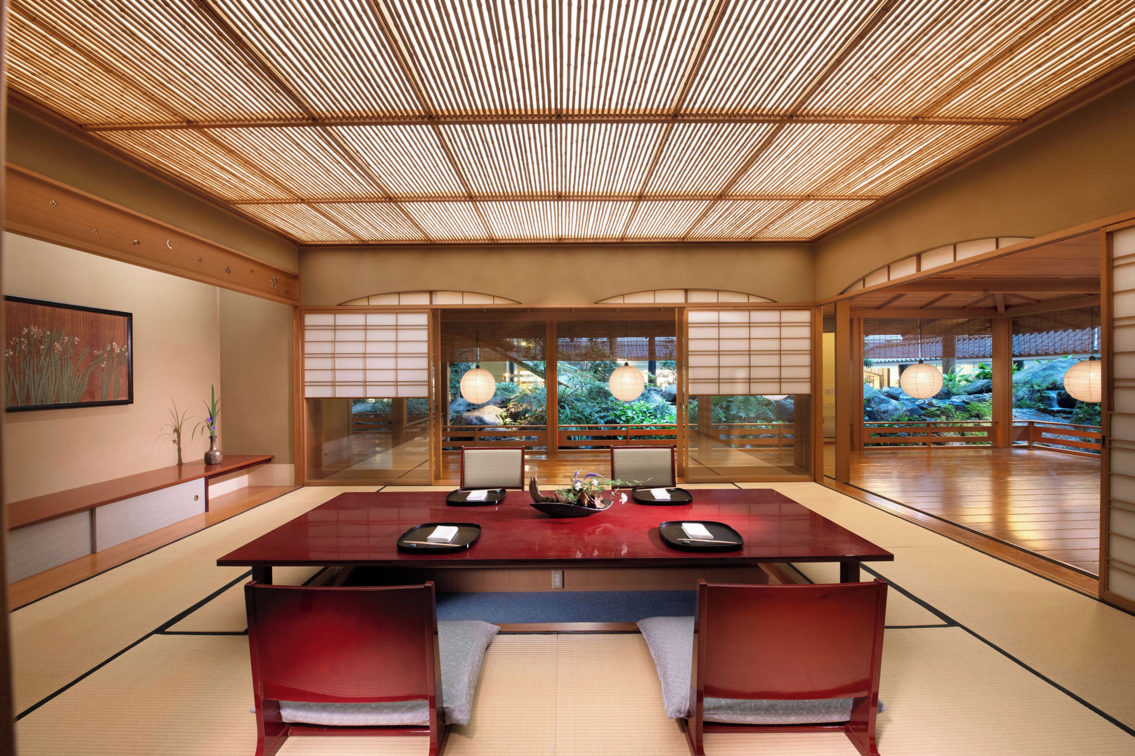 A traditional Japanese-style room with tatami flooring, a low table, and shoji screens.