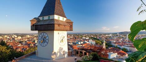A clock tower with a clear view of the surrounding cityscape.